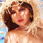 Elodya Sex Doll 168 cm IronTech, chapeau de paille, maquillage vibrant, fond tropical.