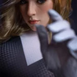 Evalie Sex Doll 167 cm IronTech en silicone, gros plan visage, main avant floue.