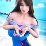 Adorelle Sex Doll 163 cm en maillot bleu, pose plage, fond tropical, IronTech Doll TPE.