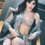 Feena Sex Doll 165 cm IronTech Doll TPE assise en lingerie délicate sur un fauteuil.