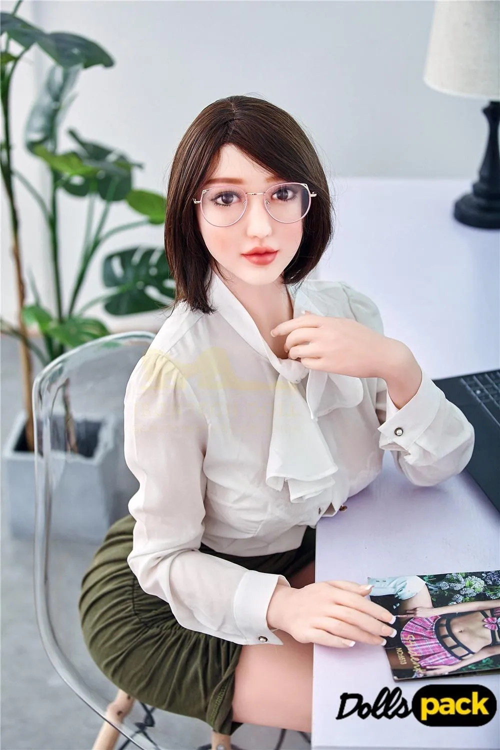 Lunaya Sex Doll 159 cm IronTech, assise, chemisier blanc, jupe verte, lunettes, ambiance bureau.