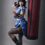 Lylia Sex Doll 158 cm IronTech en tenue de combat bleu avec un sac de frappe.