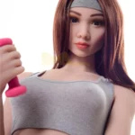 Ondine Sex Doll 168 cm IronTech Doll TPE en tenue de sport grise, tenant un haltère rose.
