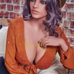 Velena Sex Doll 156 cm IronTech, pose assise, chapeau de paille, chemisier orange étoilé.